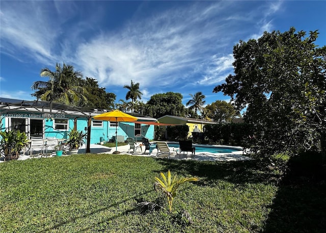 view of swimming pool featuring a patio, a lanai, and a lawn