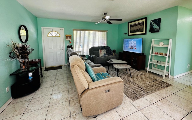 tiled living room with ceiling fan and a textured ceiling