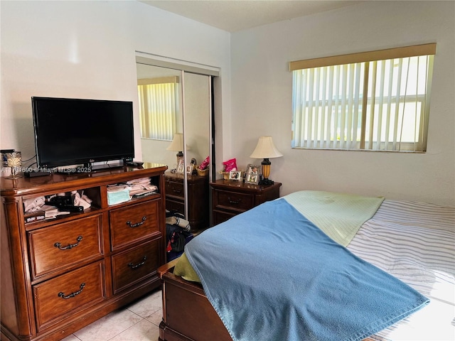 tiled bedroom with a closet