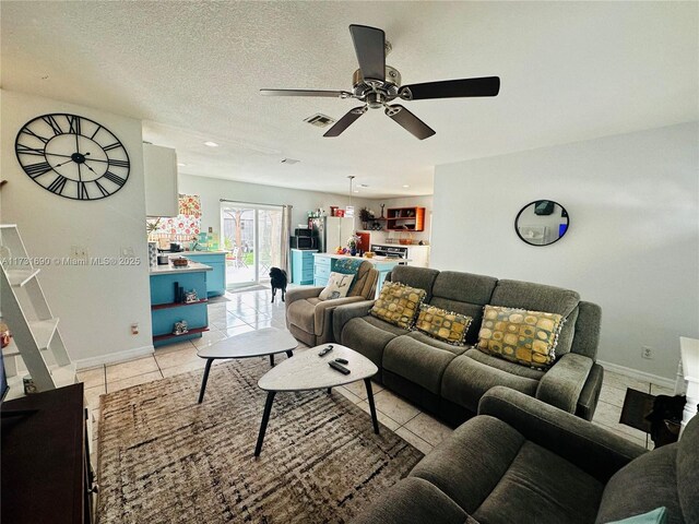 kitchen featuring hanging light fixtures, a kitchen island, washing machine and clothes dryer, light tile patterned flooring, and a barn door