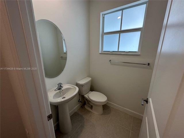 bathroom with toilet and tile patterned flooring