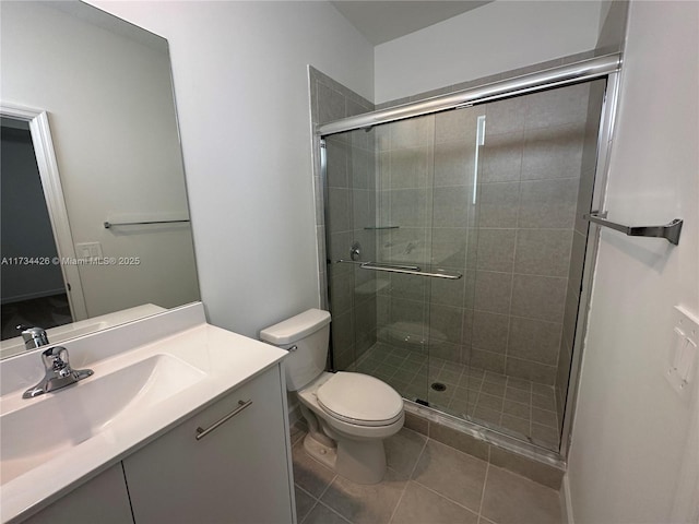 bathroom featuring tile patterned floors, toilet, an enclosed shower, and vanity