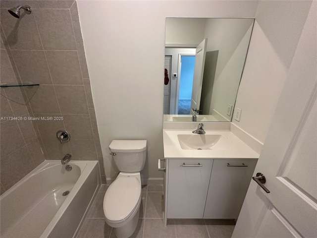 full bathroom featuring tile patterned flooring, vanity, tiled shower / bath combo, and toilet