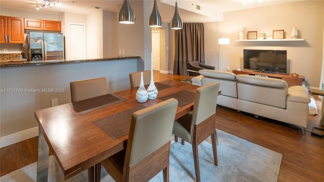 dining room with visible vents, baseboards, and wood finished floors