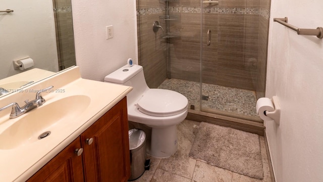 bathroom featuring a shower stall, toilet, and vanity