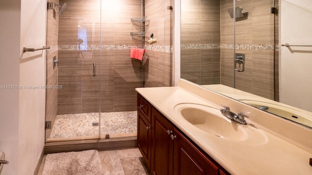 bathroom with vanity and a stall shower