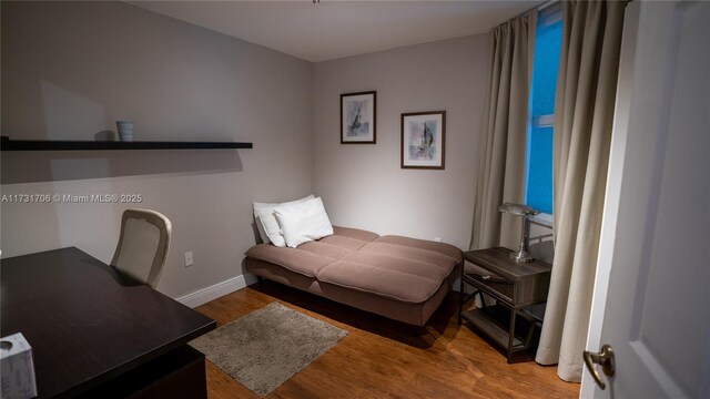 bedroom featuring baseboards and wood finished floors