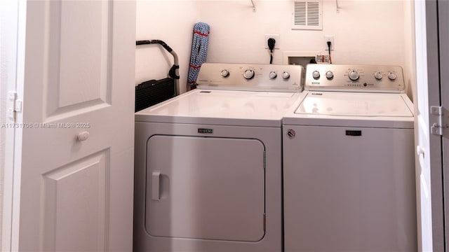 clothes washing area featuring independent washer and dryer