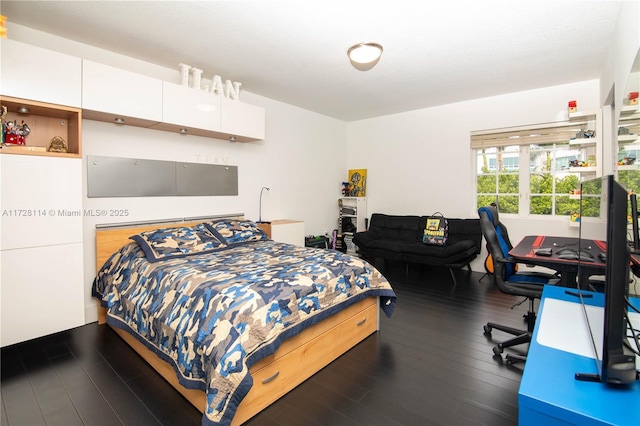 bedroom featuring dark wood finished floors