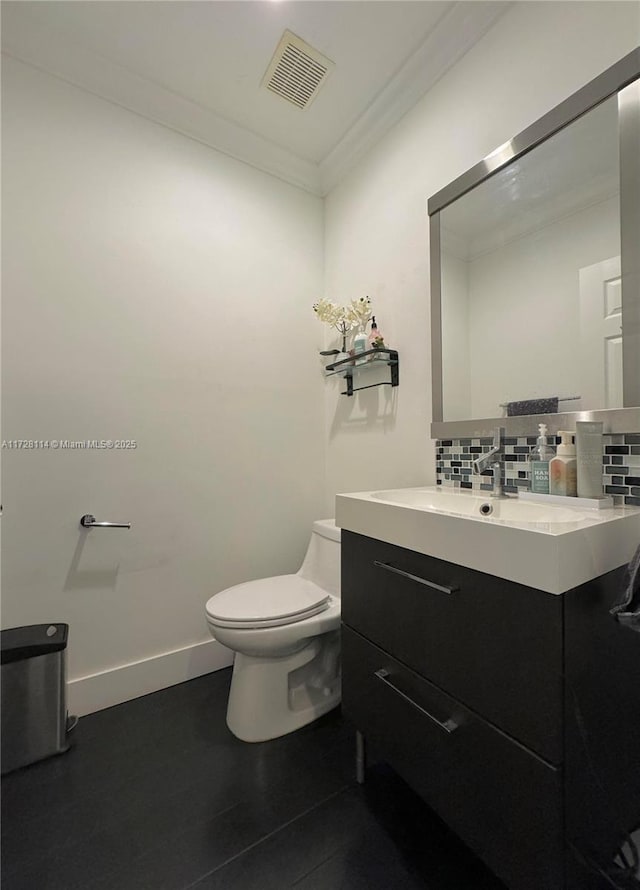 half bath featuring toilet, visible vents, backsplash, and crown molding