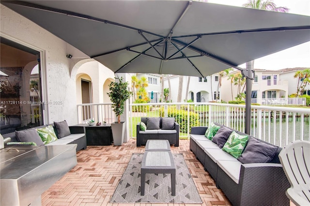 view of patio / terrace featuring outdoor lounge area and a water view