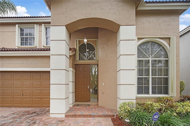 view of exterior entry featuring a garage