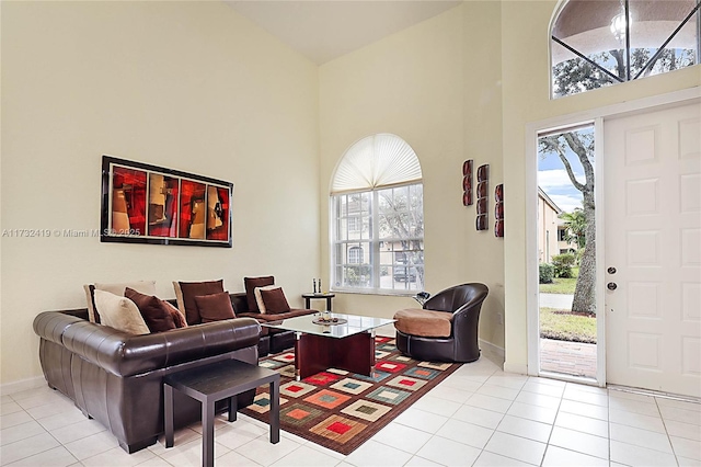 tiled living room featuring a healthy amount of sunlight and a high ceiling