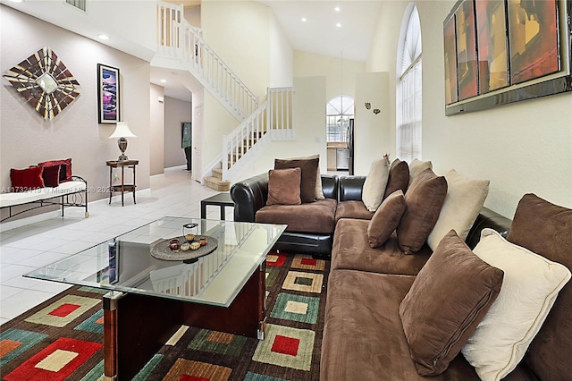 living room featuring high vaulted ceiling and light tile patterned flooring