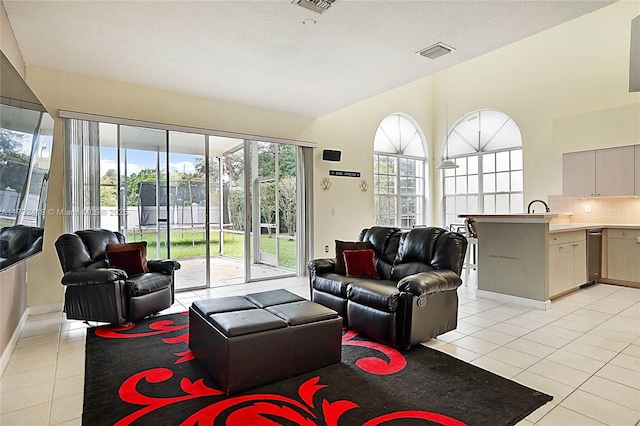 living room with light tile patterned flooring and a textured ceiling