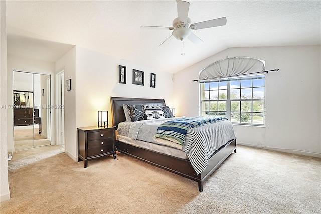 carpeted bedroom with vaulted ceiling and ceiling fan