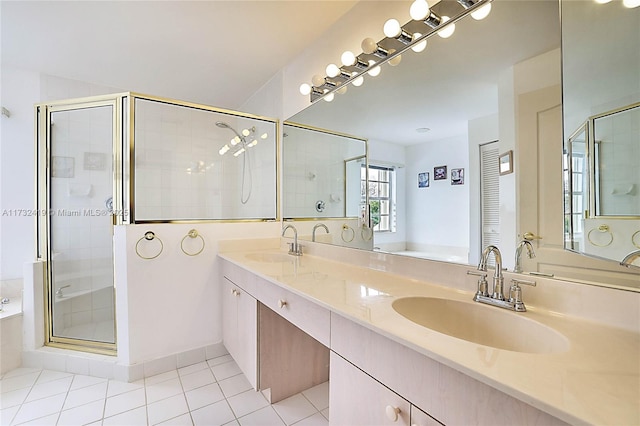 bathroom featuring tile patterned flooring, vanity, and plus walk in shower