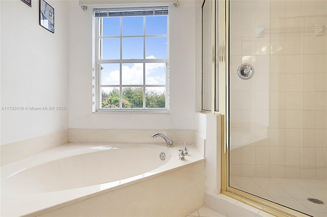 bathroom featuring independent shower and bath