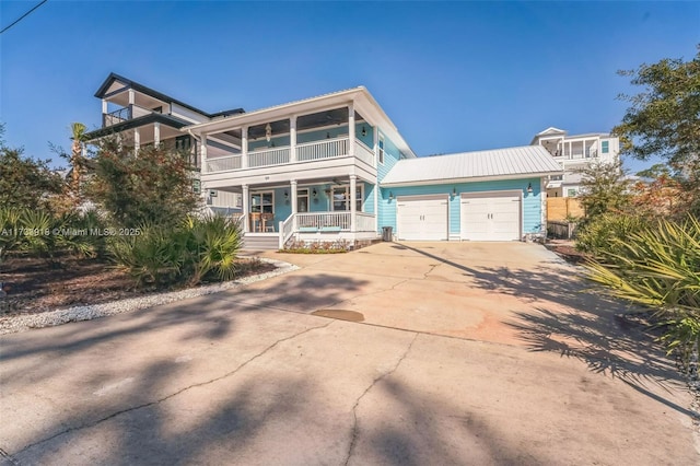 view of front of home featuring a balcony, covered porch, an attached garage, and concrete driveway