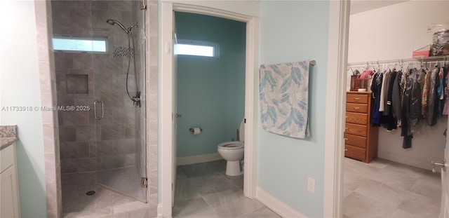 bathroom featuring vanity, toilet, and an enclosed shower