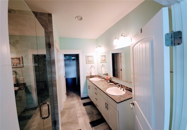 bathroom with vanity and a shower with door