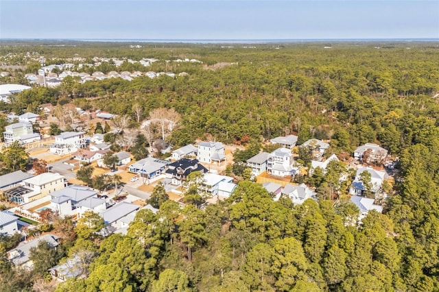 drone / aerial view featuring a residential view and a view of trees