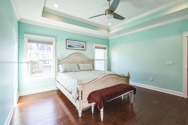 bedroom with ornamental molding, a tray ceiling, and wood-type flooring