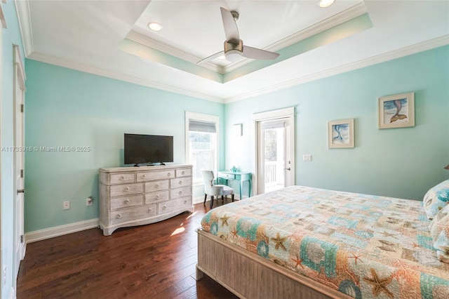 bedroom with dark wood-style floors, baseboards, ornamental molding, and a raised ceiling