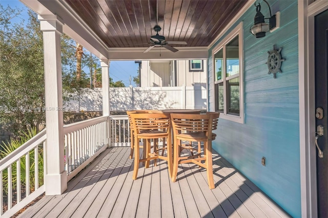 deck with a porch and a ceiling fan