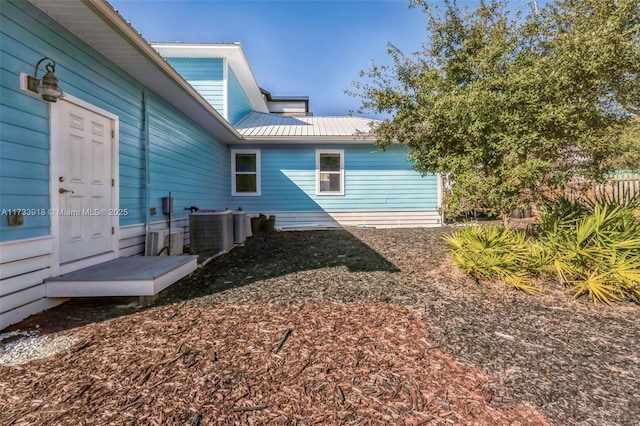 exterior space featuring metal roof and central AC unit