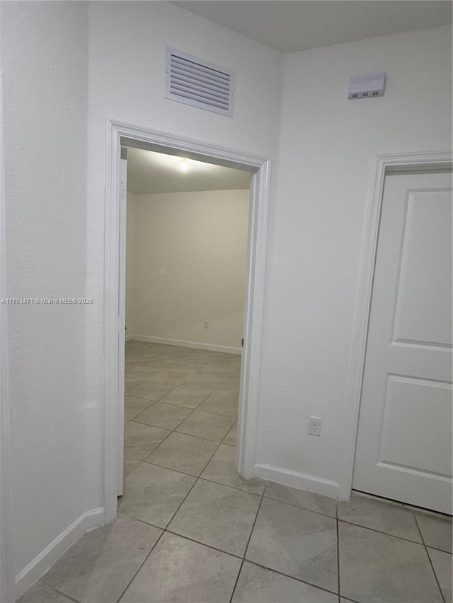 hallway featuring light tile patterned floors