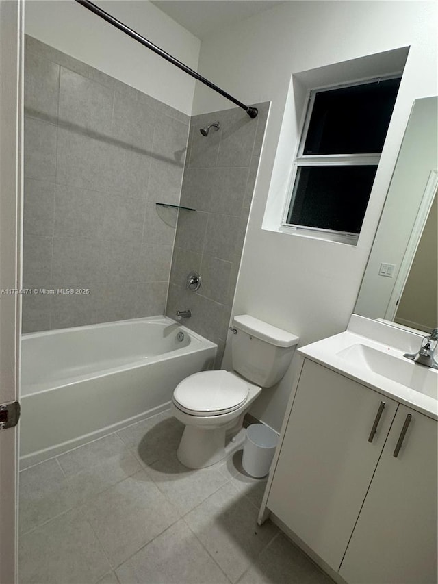 full bathroom featuring tile patterned floors, vanity, toilet, and tiled shower / bath combo