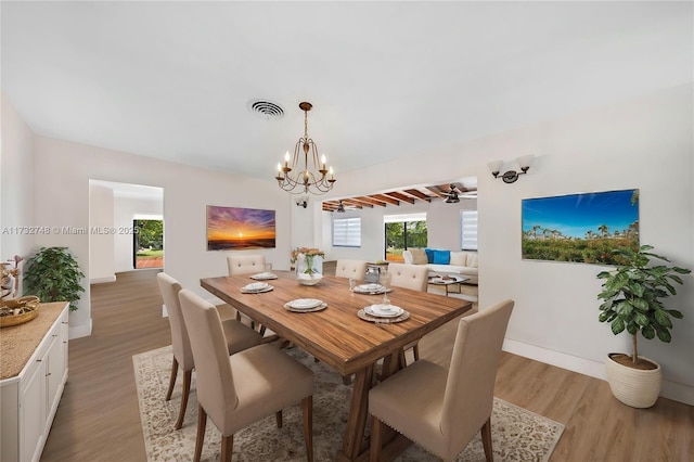 dining space with an inviting chandelier and light wood-type flooring