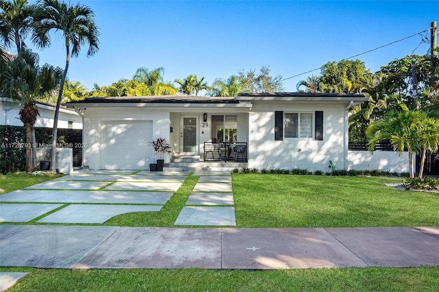 ranch-style home with a garage and a front lawn