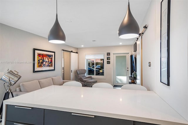 kitchen with hanging light fixtures and a barn door