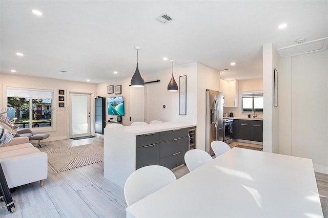 dining room with wine cooler and light wood-type flooring