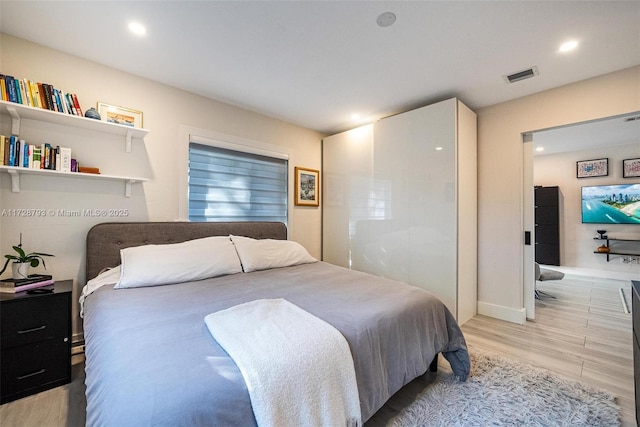 bedroom featuring light hardwood / wood-style floors