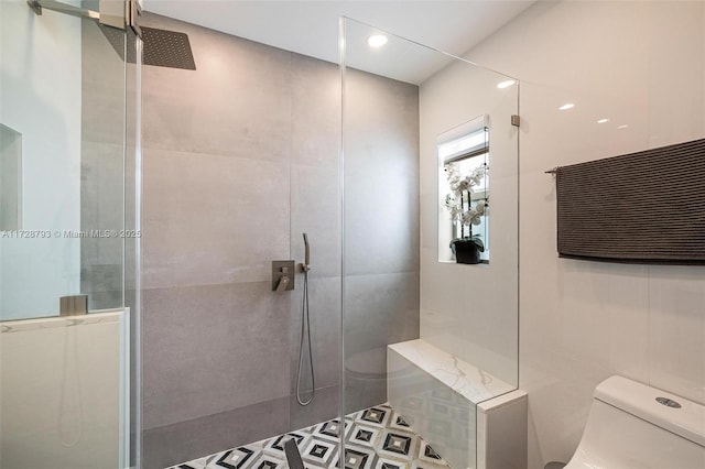 bathroom featuring toilet, tile walls, and a tile shower