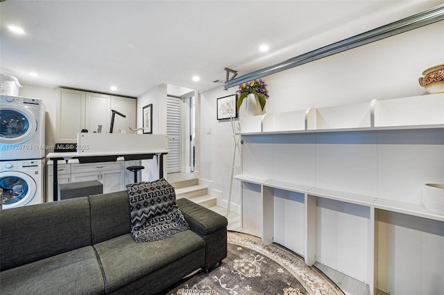 living room featuring stacked washer / dryer