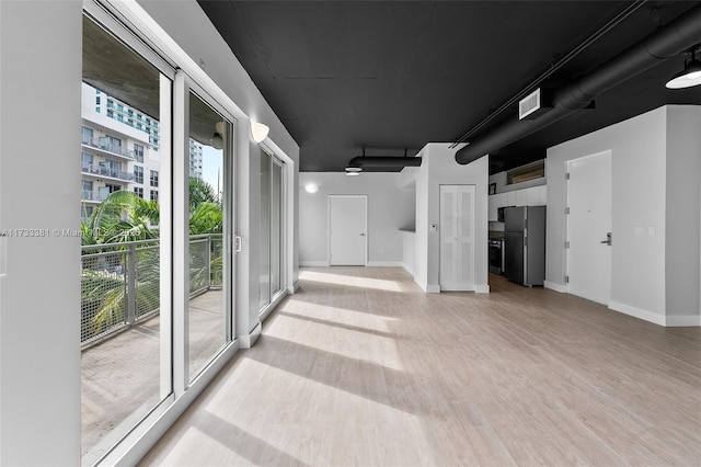 hall with light wood-type flooring