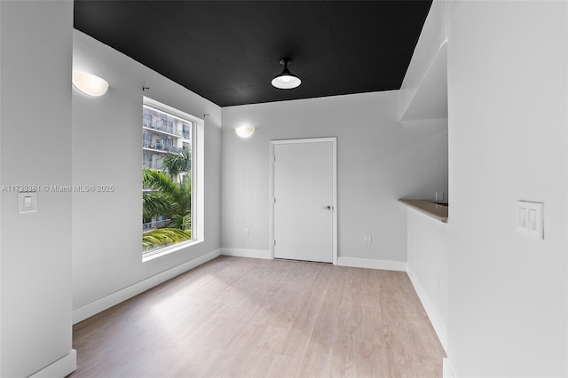 unfurnished room with light hardwood / wood-style floors