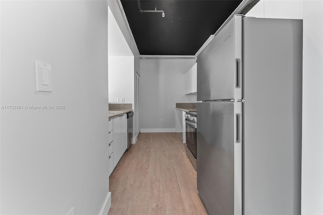 kitchen featuring stainless steel appliances, white cabinets, and light hardwood / wood-style flooring