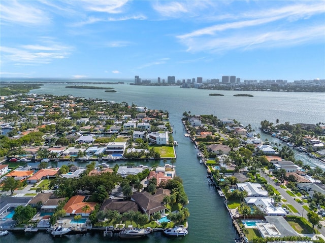 birds eye view of property featuring a view of city and a water view