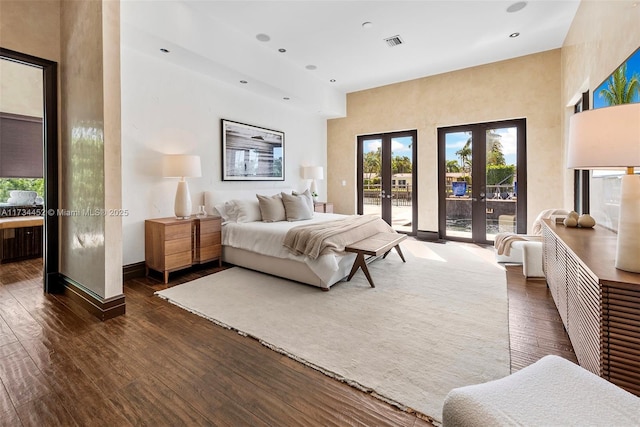 bedroom with access to outside, visible vents, wood-type flooring, and french doors