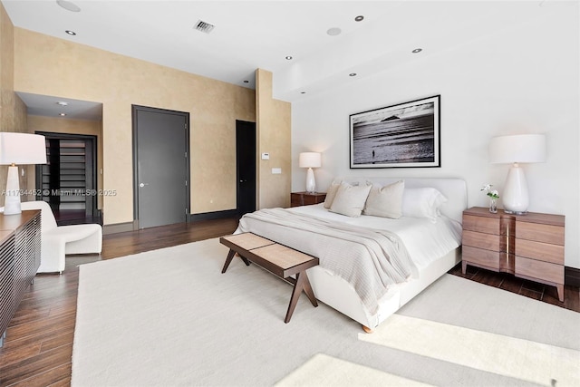 bedroom featuring recessed lighting, dark wood finished floors, visible vents, and baseboards