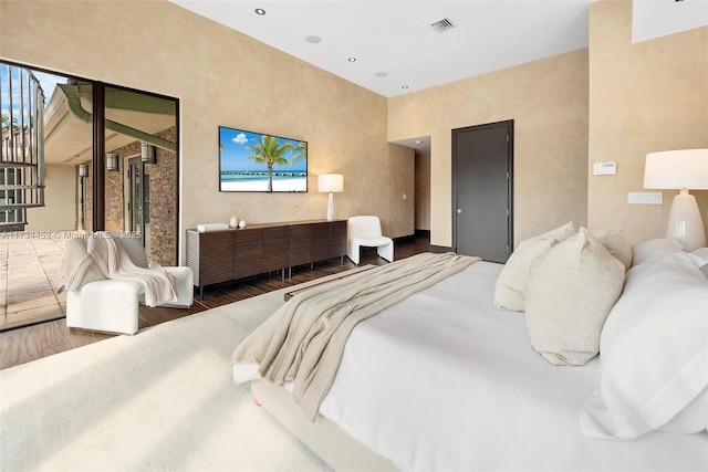 bedroom with wood finished floors and visible vents