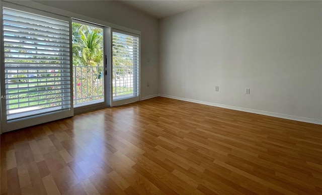 unfurnished room with wood-type flooring