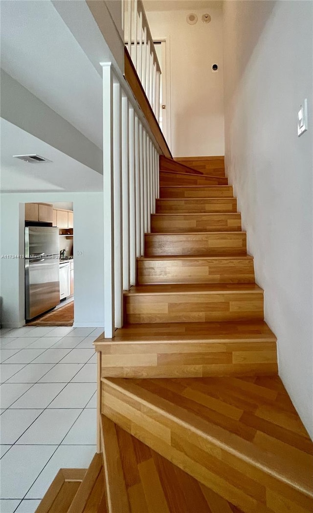 stairs featuring tile patterned flooring