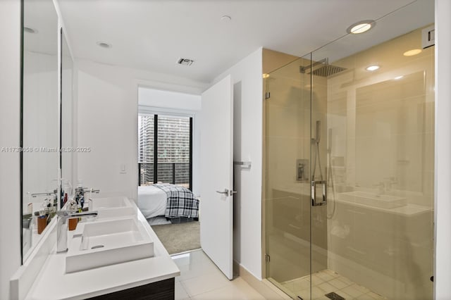 bathroom with tile patterned flooring, vanity, and an enclosed shower