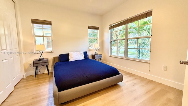 bedroom featuring wood finished floors and baseboards